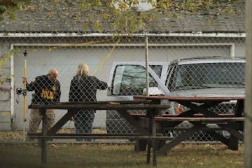 St. Paul Police investigators worked the scene in an alley on St. Paul's East Side Sunday afternoon where Naressa Turner, 20, was shot to death while 