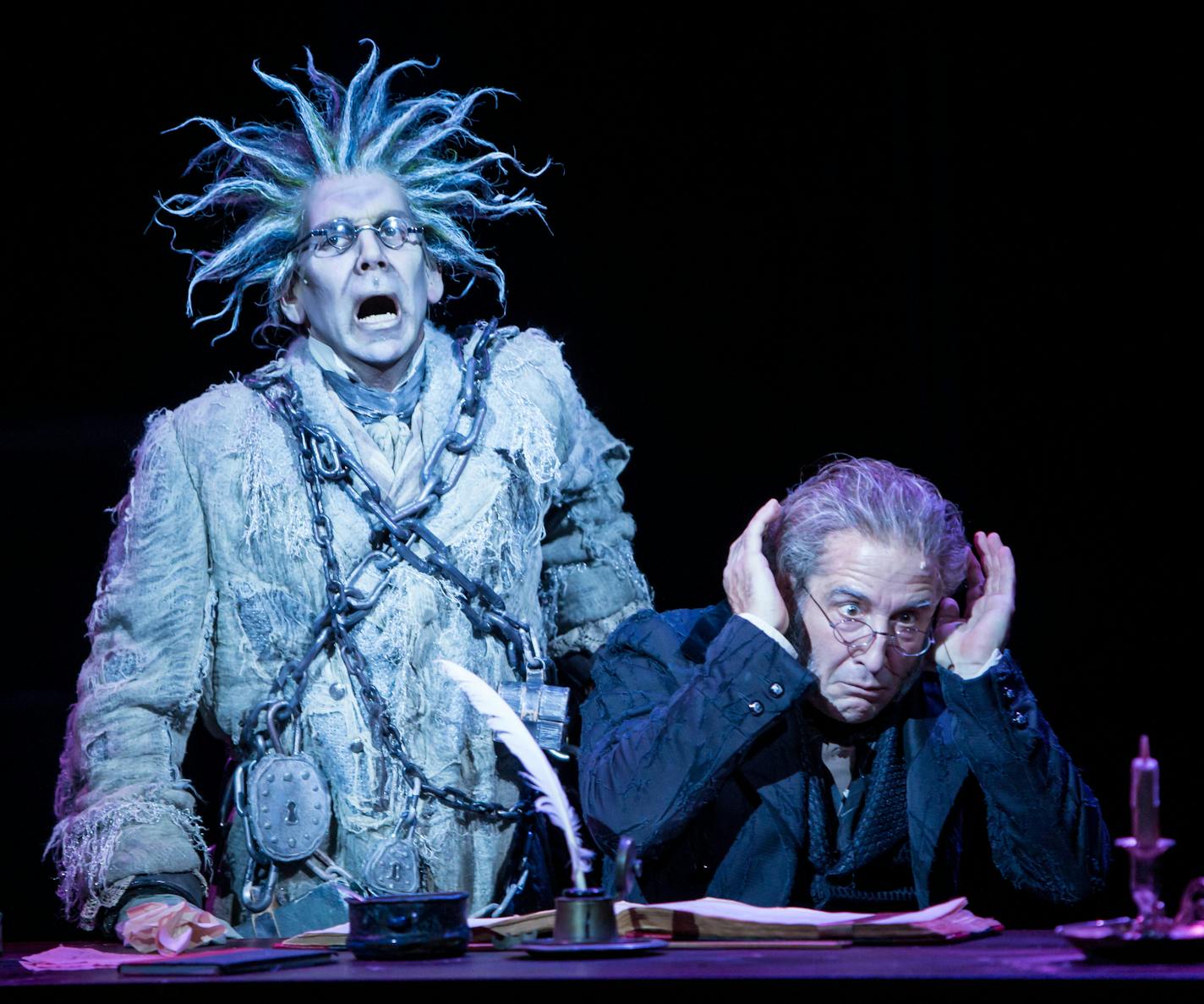 Robert O. Berdahl (Jacob Marley) and J.C. Cutler (Ebenezer Scrooge) in the Guthrie Theater's 41st annual production of the Charles Dickens classic, A Christmas Carol, adapted by Crispin Whittell and directed by Joe Chvala with set design by Walt Spangler, costume design by Mathew J. LeFebvre and lighting design by Christopher Akerlind. November 12 - December 27, 2015 on the Wurtele Thrust Stage at the Guthrie Theater, Minneapolis. Photo by Dan Norman.