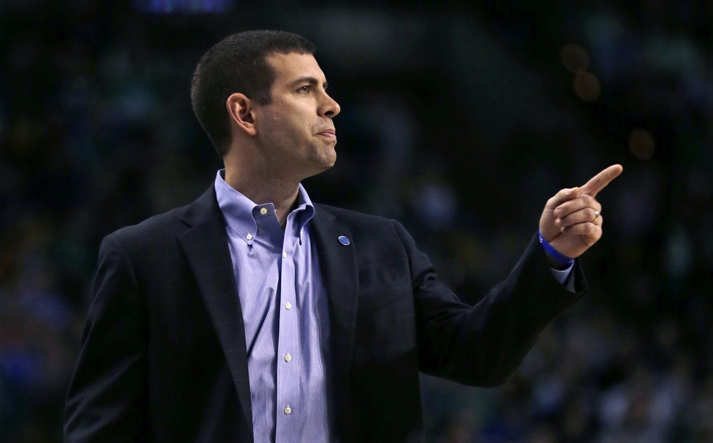 Boston Celtics coach Brad Stevens calls to his players during the first quarter of an NBA basketball game against the Minnesota Timberwolves in Boston, Monday, Dec. 21, 2015.