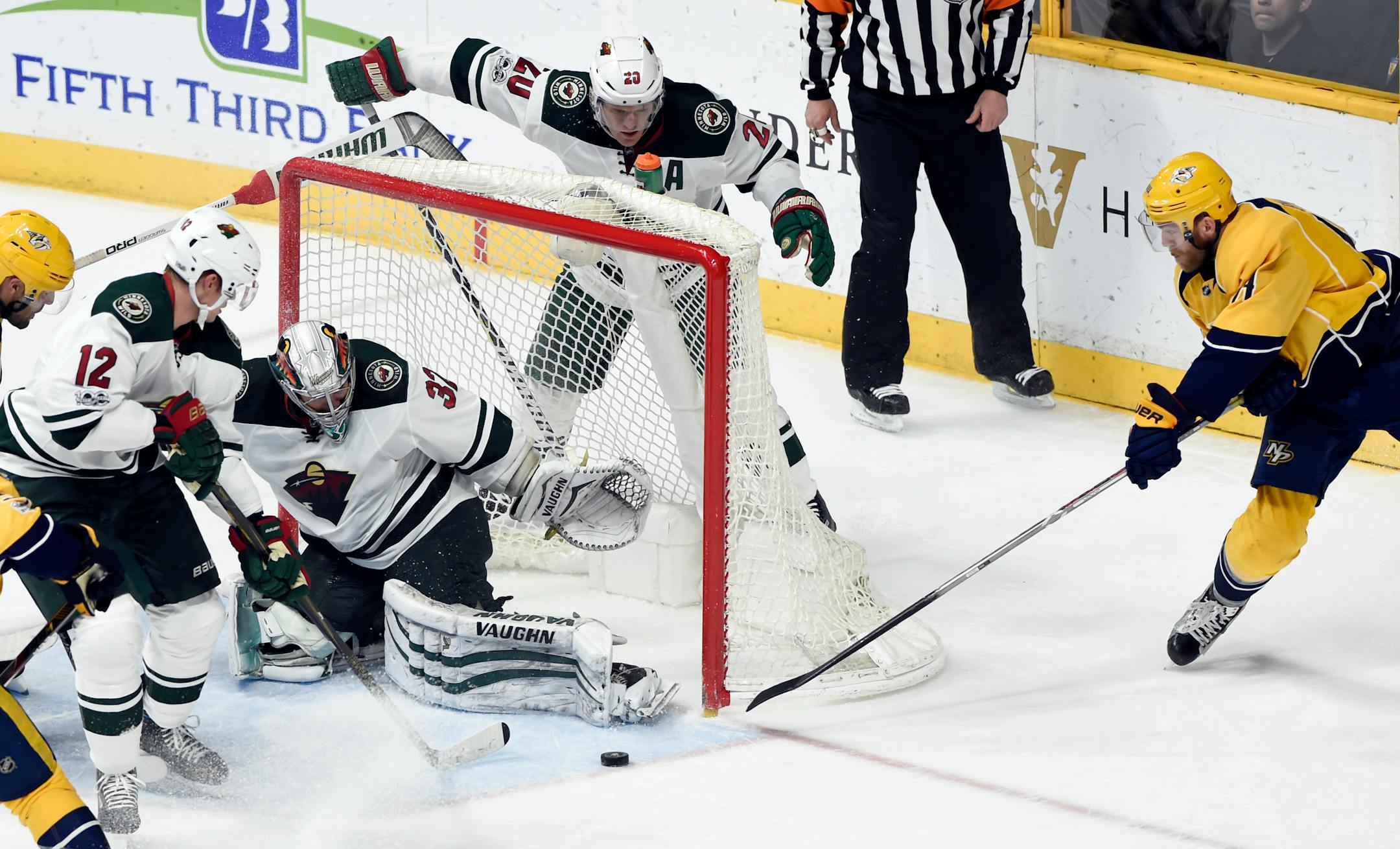 Minnesota Wild goalie Alex Stalock (32) blocks a shot by Nashville Predators defenseman Ryan Ellis, right, during the third period of an NHL hockey game Saturday, April 1, 2017, in Nashville, Tenn. The Predators won 3-0. (AP Photo/Mark Zaleski)