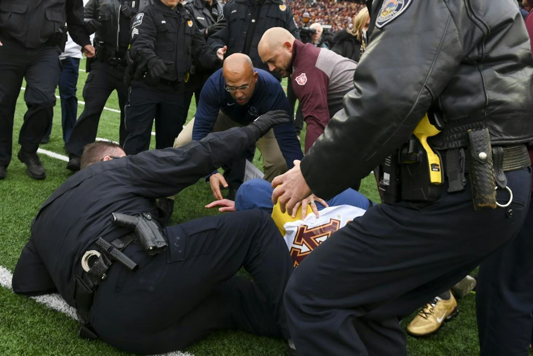 It was chaos at center field as a police officer and cameraman were trampled as Minnesota Gophers head coach P.J. Fleck and Penn State Nittany Lions head coach James Franklin went to shake hands.
