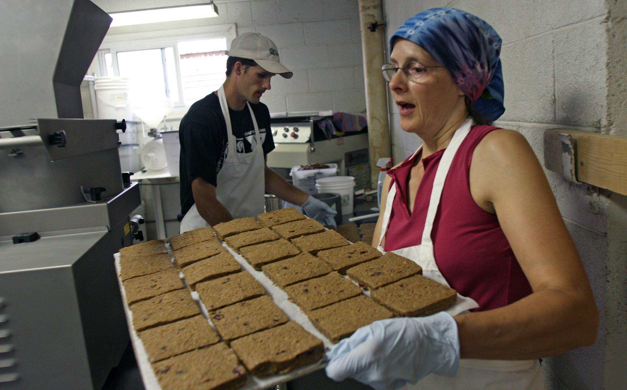 Seth Couenhoven and his mom, Sarah, placed trays of their Thuro Bread nutrition bars on trays for baking. The small start-up company rents commercial kitchen space from St. Paul Incubator Kitchen. The Couenhovens have been coming to the bakery every Wednesday since January.