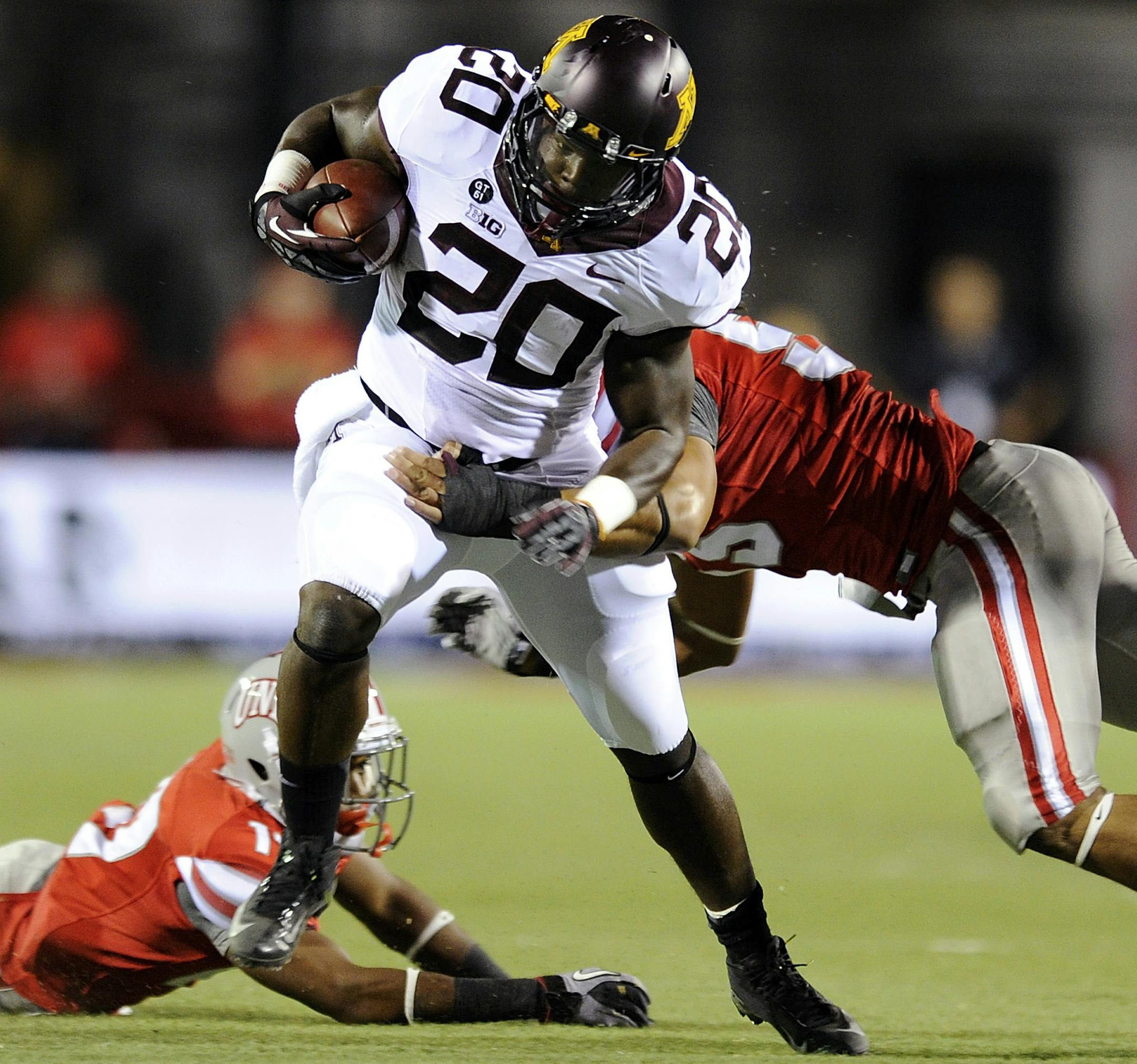 Minnesota's Donnell Kirkwood (20) rushes against the UNLV defense during an NCAA college football game, Thursday, Aug. 30, 2012, in Las Vegas. (AP Photo/David Becker) ORG XMIT: MIN2012090720080422