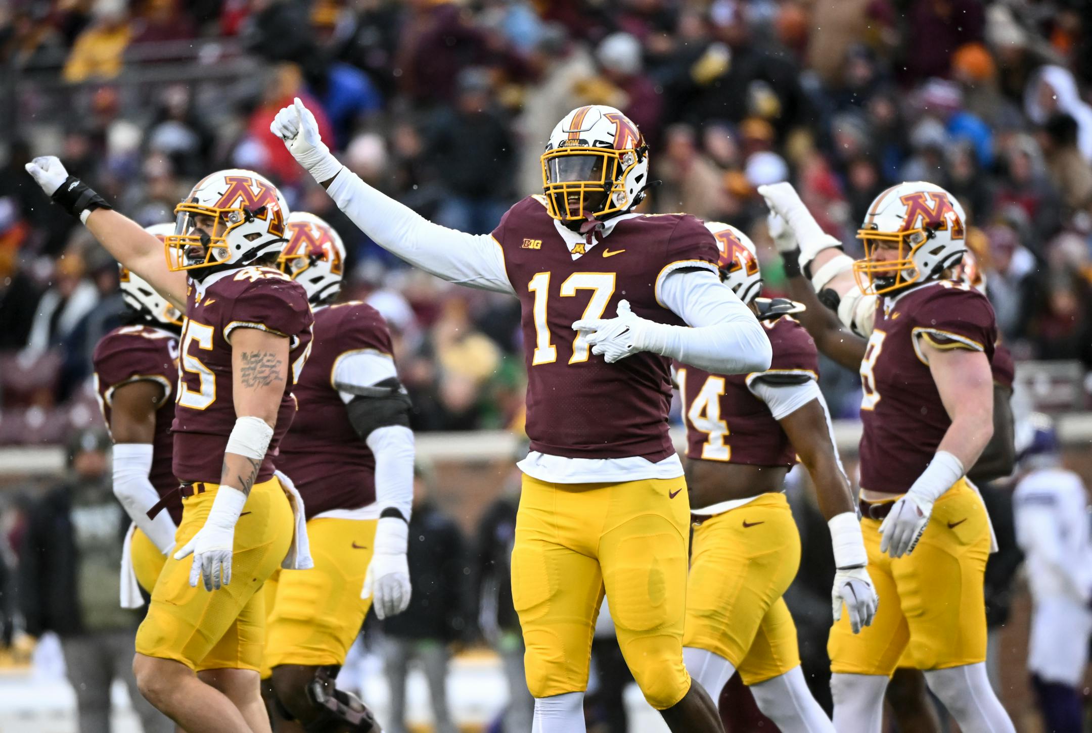 Minnesota Gophers, including defensive lineman Jah Joyner (17), celebrate after forcing a punt on a fourth down against the Northwestern Wildcats during the first half.