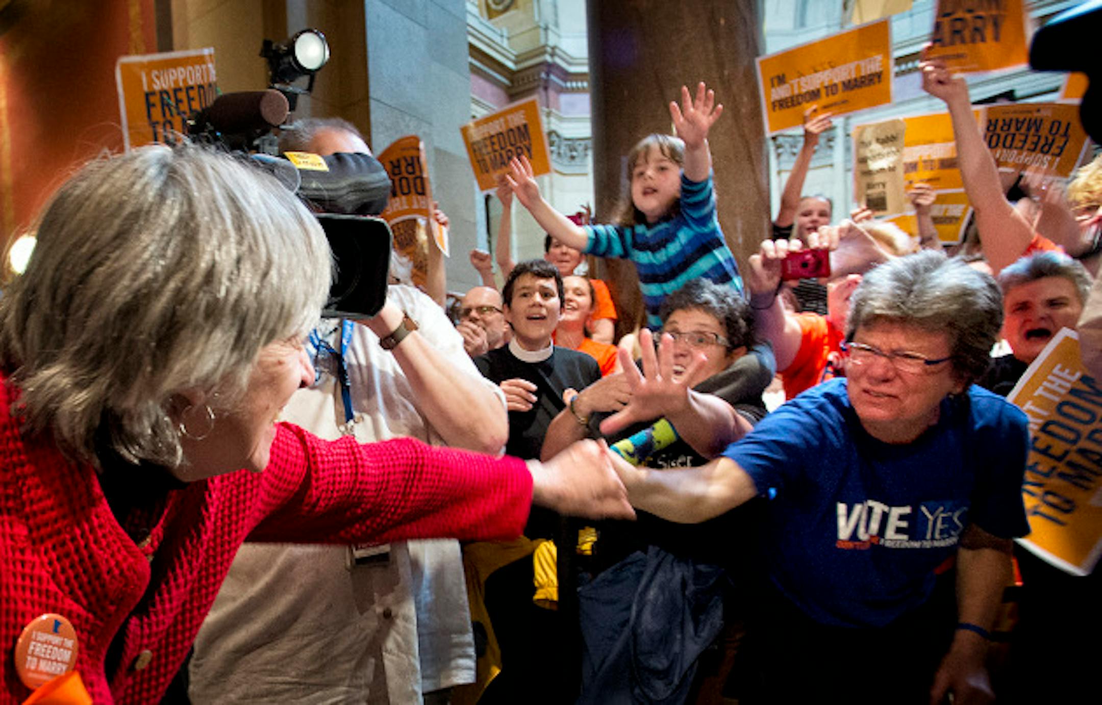 While her partner Jacqueline Zita held on to keep her from falling, Rep. Karen Clark, greed supporters as they came out of the House chamber after passage of the bill 75-59   Thursday, May 9, 2013.     ]   GLEN STUBBE * gstubbe@startribune.com  Rep. Karen Clark greeted supporters emerged from House chambers after the vote. Thursday, May 9, 2013.     ]   GLEN STUBBE * gstubbe@startribune.com