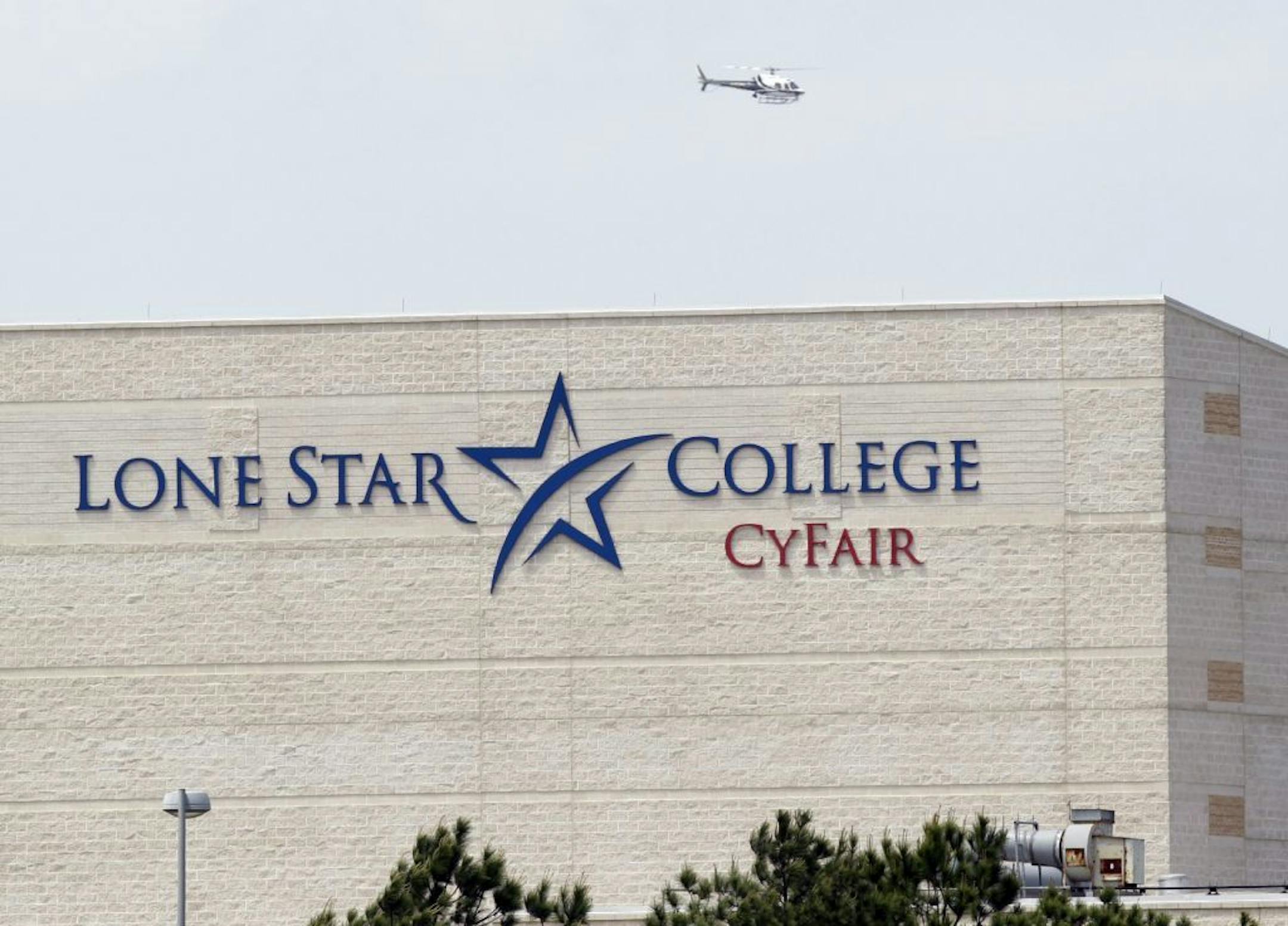 A police helicopter circles above the Cy-Fair campus of Lone Star Community College in Cypress, Texas, where officials say about a dozen people have been wounded in a stabbing attack Tuesday, April 9, 2013. The Harris County Sheriff's department confirmed at least 11 people wounded and that authorities have one suspect in custody.