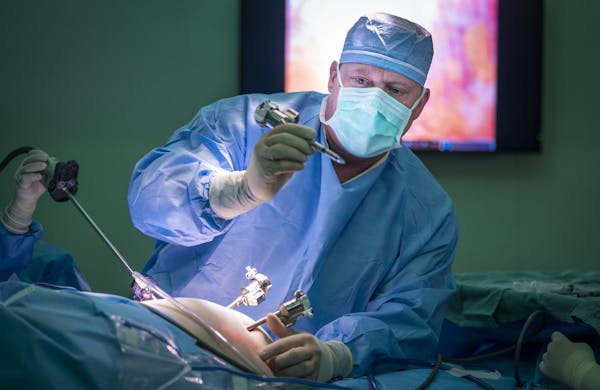 Dr. Jared Slater prepared a patient for robotic gall bladder surgery at RC Hospital and Clinics in Olivia, Minn. The hospital gambled that investing i