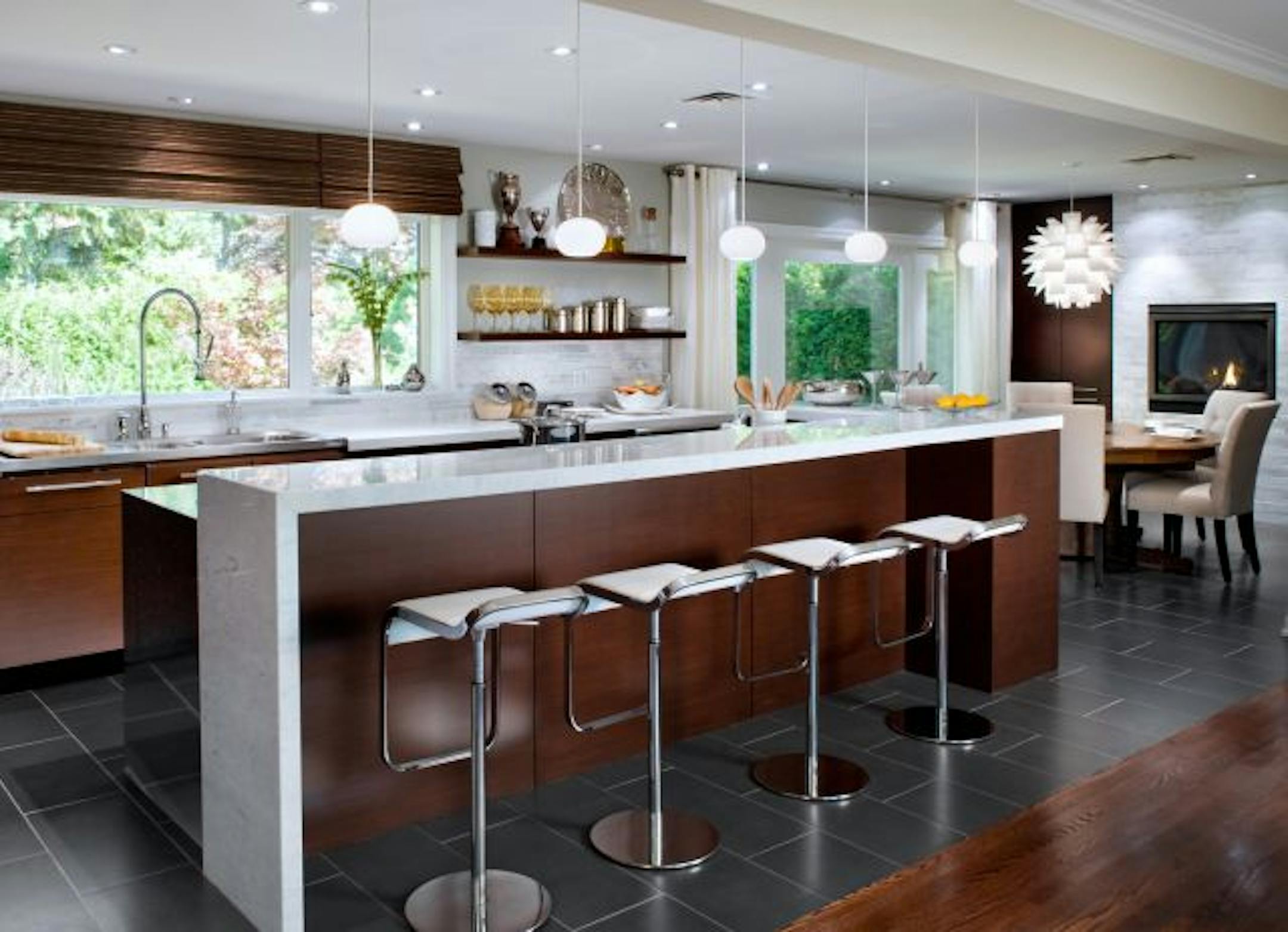 AFTER A blend of modern convenience with retro charm — including five pendants over the island – brought this kitchen into the current century while retaining clean lines and function.