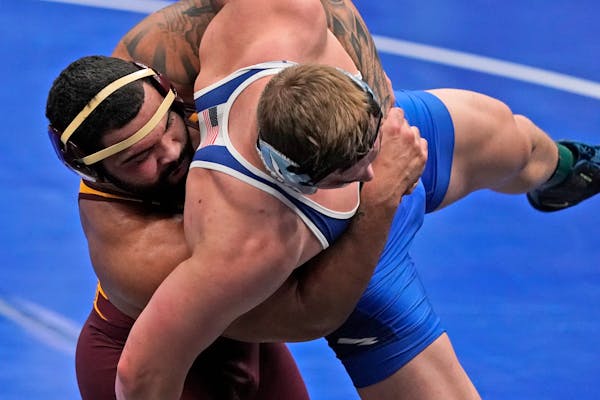 Minnesota's Gable Steveson, left, takes on Air Force's Wyatt Hendrickson during their 285-pound match in the second round