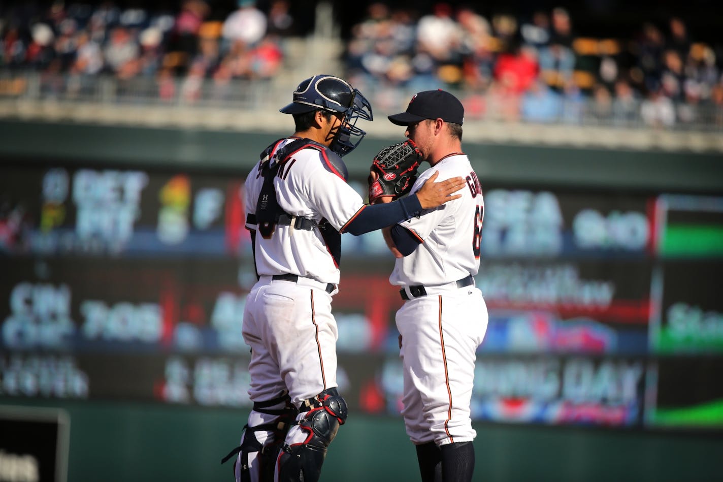 Catcher Kurt Suzuki talks to pitcher J.R. Graham during the Twins home opener against the Kansas City Royals at Target Field in Minneapolis on Monday, April 13, 2015.