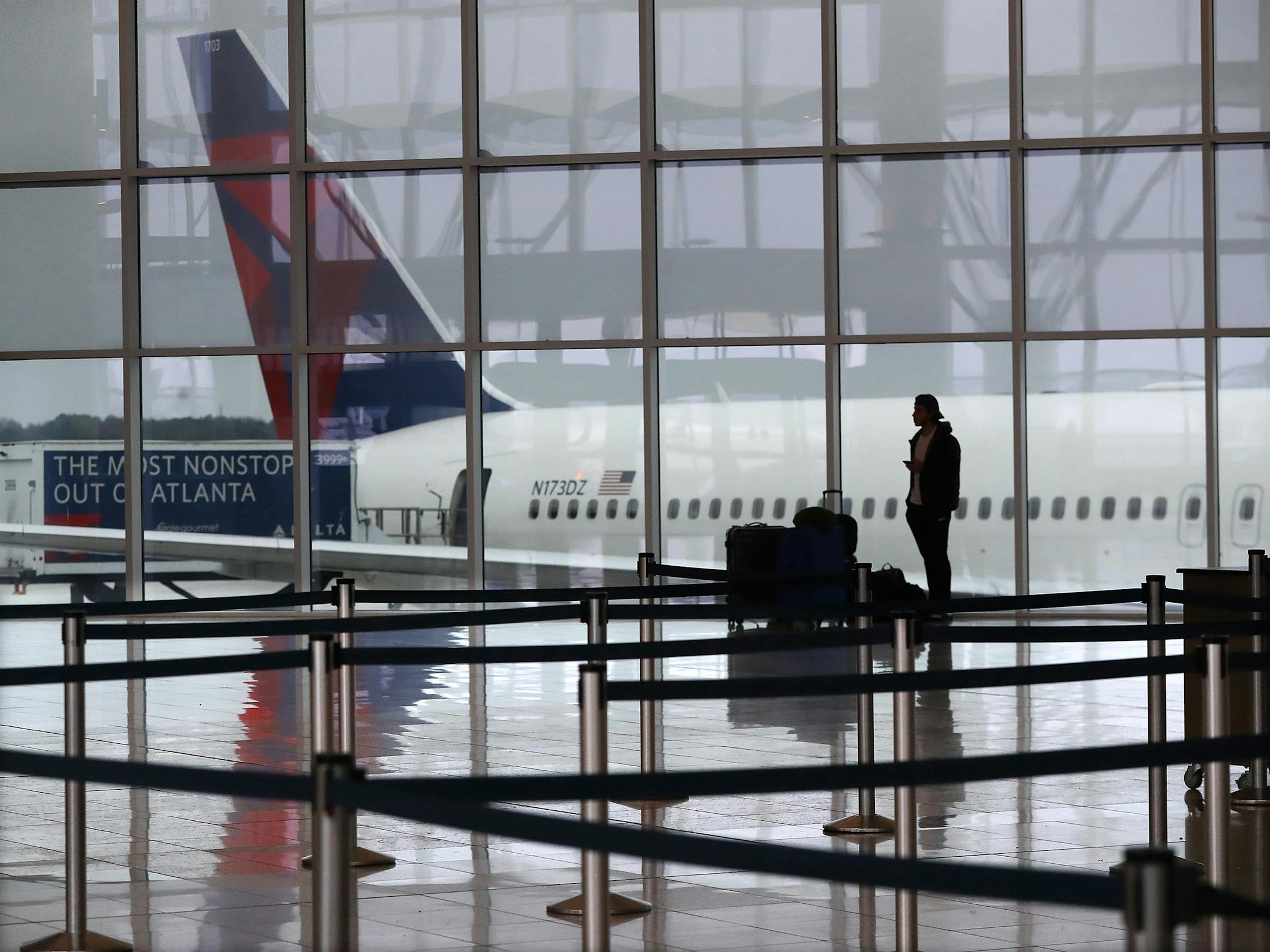 A Delta plane sits at the International Terminal at Atlanta's Hartsfield-Jackson International Airport in March 2020. (Curtis Compton/Atlanta Journal-Constitution/TNS) ORG XMIT: 53730701W