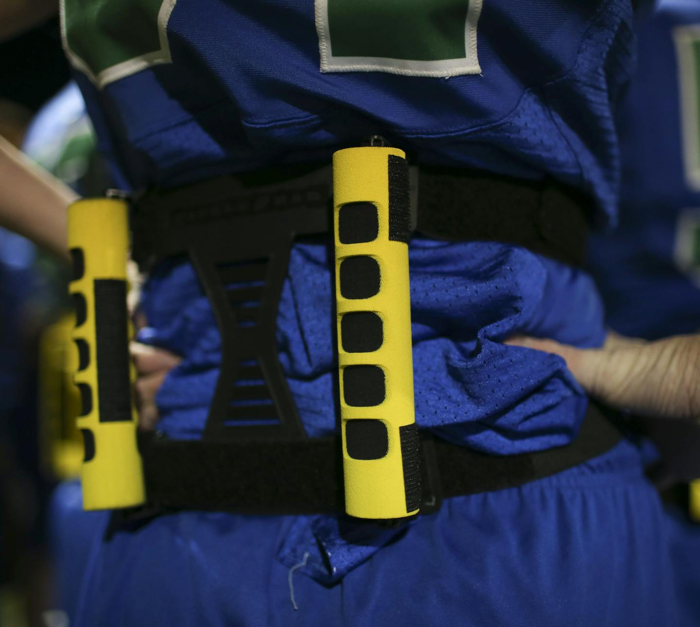 Detail of the pair of bars on a Blake player's back Monday night. ] JEFF WHEELER &#x2022; jeff.wheeler@startribune.com The IMAC Conference has begun an initiative to help bring back football to the schools called Fusion Football. It's for middle schoolers and it's basically modified flag football using helmets and shoulder pads. There is no tackling and minimal contact while teaching proper technique so kids are prepared for tackle football when they reach high school. Blake hosted Providence Ac