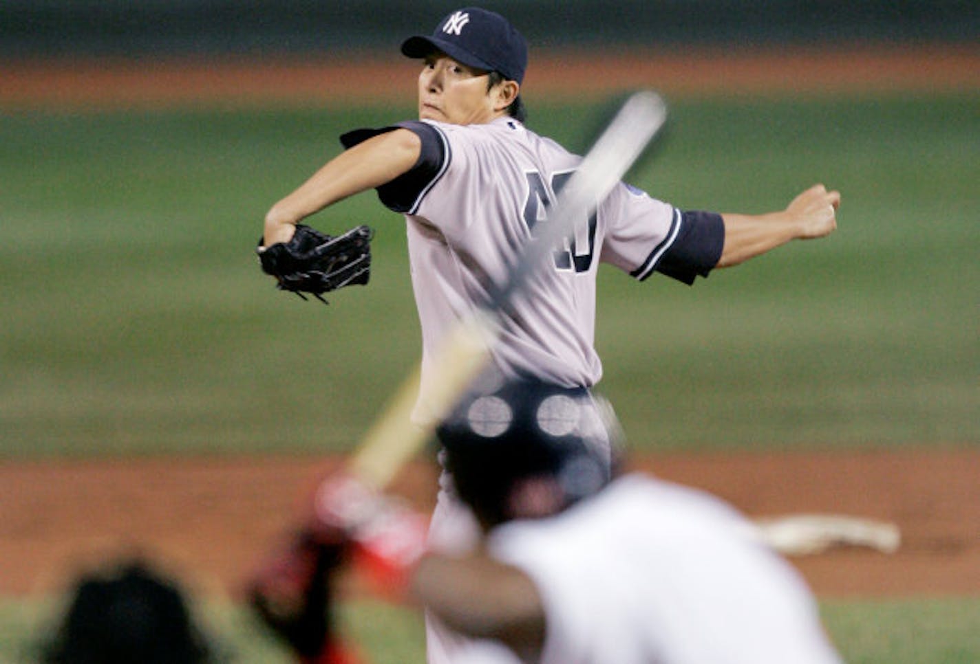 New York Yankees starter Chien-Ming Wang, of Taiwan, delivers to Boston Red Sox designated hitter David Oritz during the first inning of their baseball game at Fenway Park in Boston, Friday, April 11, 2008.