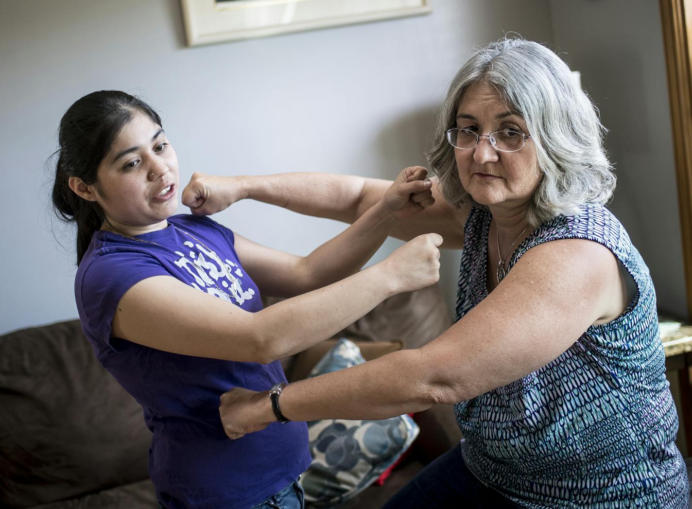 Anhelica Van Den Burgh, 24, reenacted a situation in which a foster child that was in the care of her and mother, Marsha Van Den Burgh, right, pulled a knife on Anhelica during an argument. ] (AARON LAVINSKY/STAR TRIBUNE) aaron.lavinsky@startribune.com Photos to accompany story on foster care regulation. We photograph Marsha Van Den Burgh, a foster parent who says she's not paid nearly enough for the work and considering quitting. Wednesday, June 8, 2016 in Oak Grove, Minn.