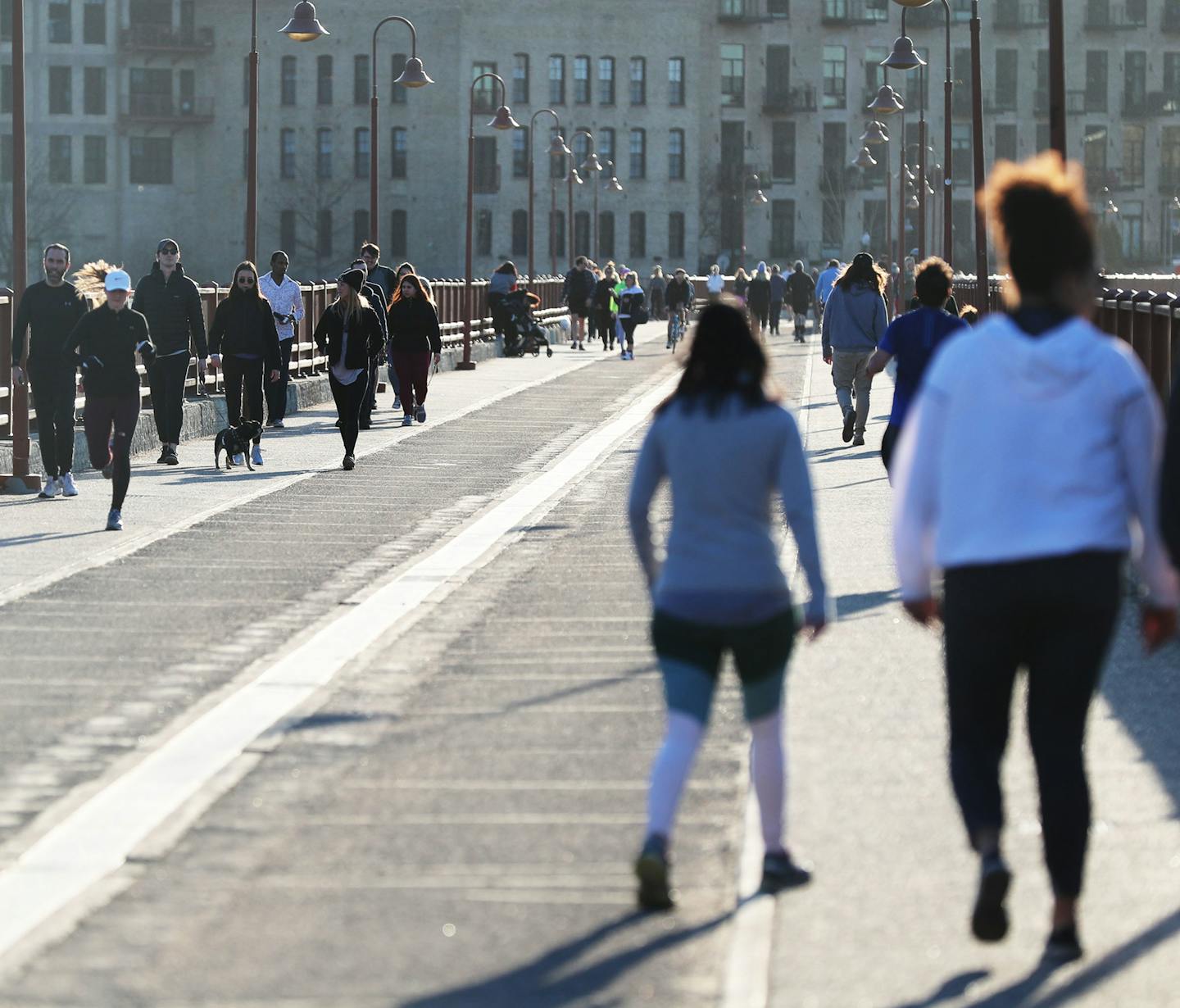 With sunny spring weather becoming the norm, people are getting out and embracing the warmer temps while not all practicing social distancing as evidenced the Stone Arch Bridge on Wednesday.