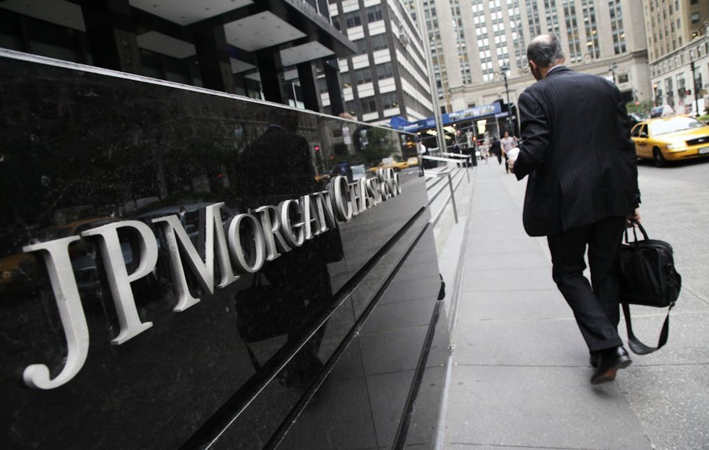 A man arrives at a JPMorgan Chase office building in New York Monday, May 14, 2012. JPMorgan, the largest bank in the United States, is seeking to minimize the damage caused by a $2 billion trading loss, disclosed Thursday by CEO Jamie Dimon.