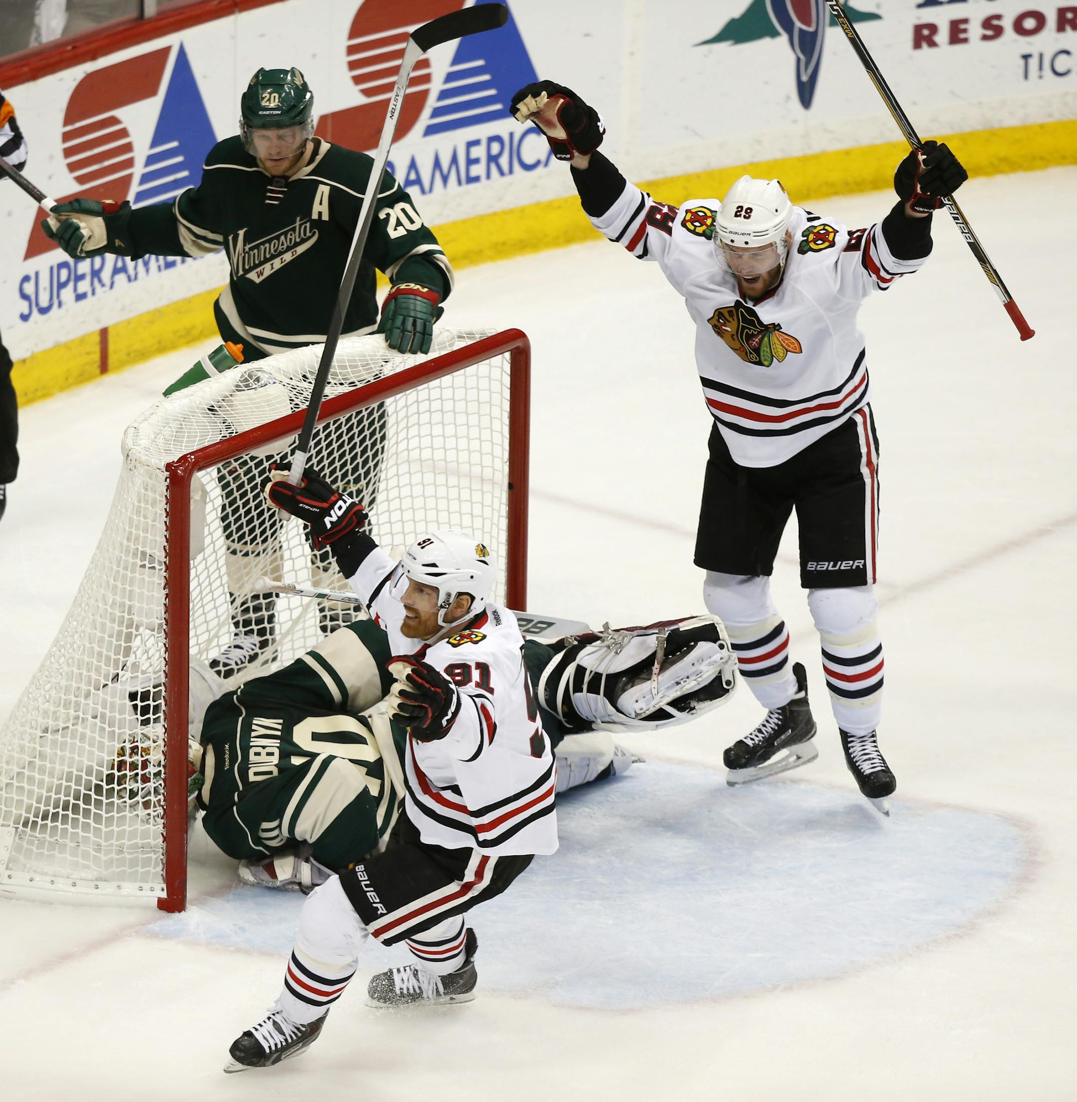 Chicago Blackhawks left wing Bryan Bickell (29) and center Brad Richards (91) celebrated a goal by Chicago Blackhawks right wing Patrick Kane (88), not pictured, late in the third period as Minnesota Wild goalie Devan Dubnyk (40) gets off the ice. ] CARLOS GONZALEZ cgonzalez@startribune.com, May 7, 2015, St. Paul, MN, Xcel Energy Center, NHL, Minnesota Wild vs. Chicago Blackhawks, Game 4, Stanley Cup Playoffs, Round 2