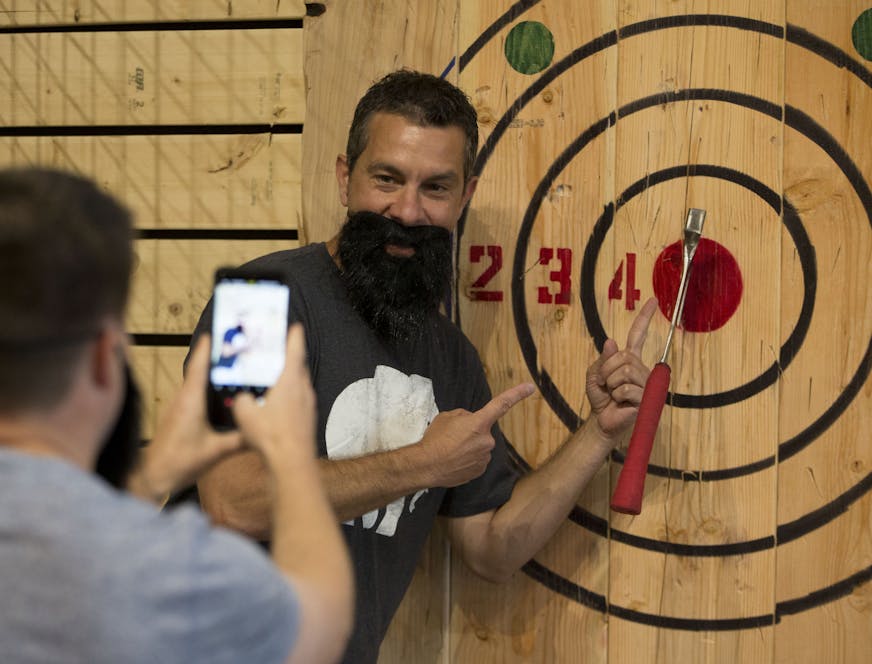 Jason Kimmel poses for a photo with his first bullseye with axe throwing. ] ALEX KORMANN &#x2022; alex.kormann@startribune.com FlannelJax's Axe Throwing is nestled in a large old industrial building in St. Paul, MN. From the outside it looks to be abandoned but up the stairs and to the right you will find twelve wooden targets mounted on the wall and people of all shapes and sizes hurling axes at them. Along side the axe throwing there is log sawing, inflatable log rolling and other games. $25 g