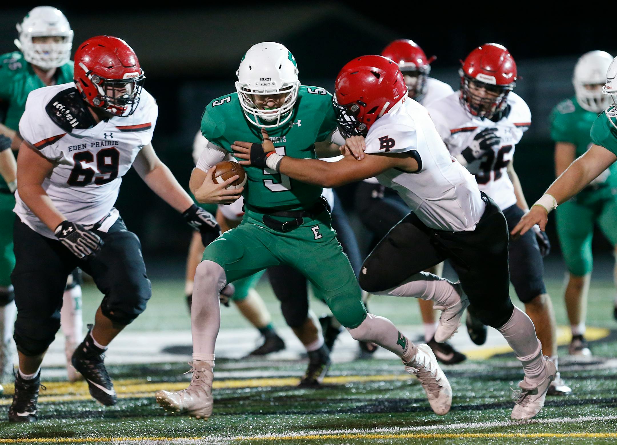 Edina High School quarterback Ryan Meyer (5) is tackled by Eden Prairie High School linebacker Antonio Montero (1) in the second half. ] LEILA NAVIDI � leila.navidi@startribune.com BACKGROUND INFORMATION: Eden Prairie High School football at Edina High School on Wednesday, October 18, 2017. Eden Prairie won 35-10.