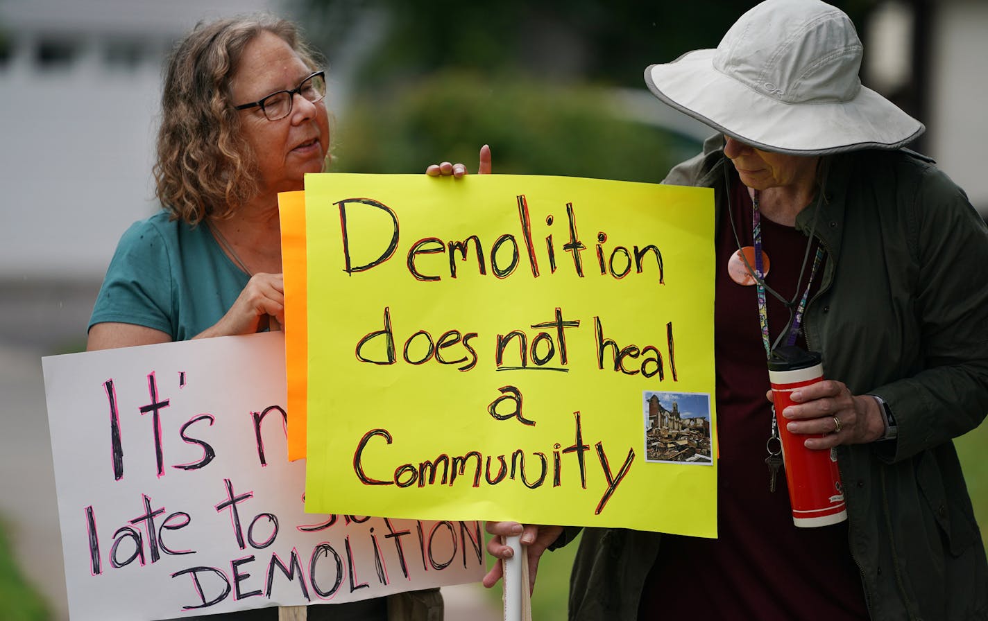 The Twin Cities German Immersion School held an open house Sunday in the former St. Andrew's Church, but Bonnie Youngquist, left, and Barbara Bezat, an architectural historian, disagreed with the "healing" purpose of the open house.