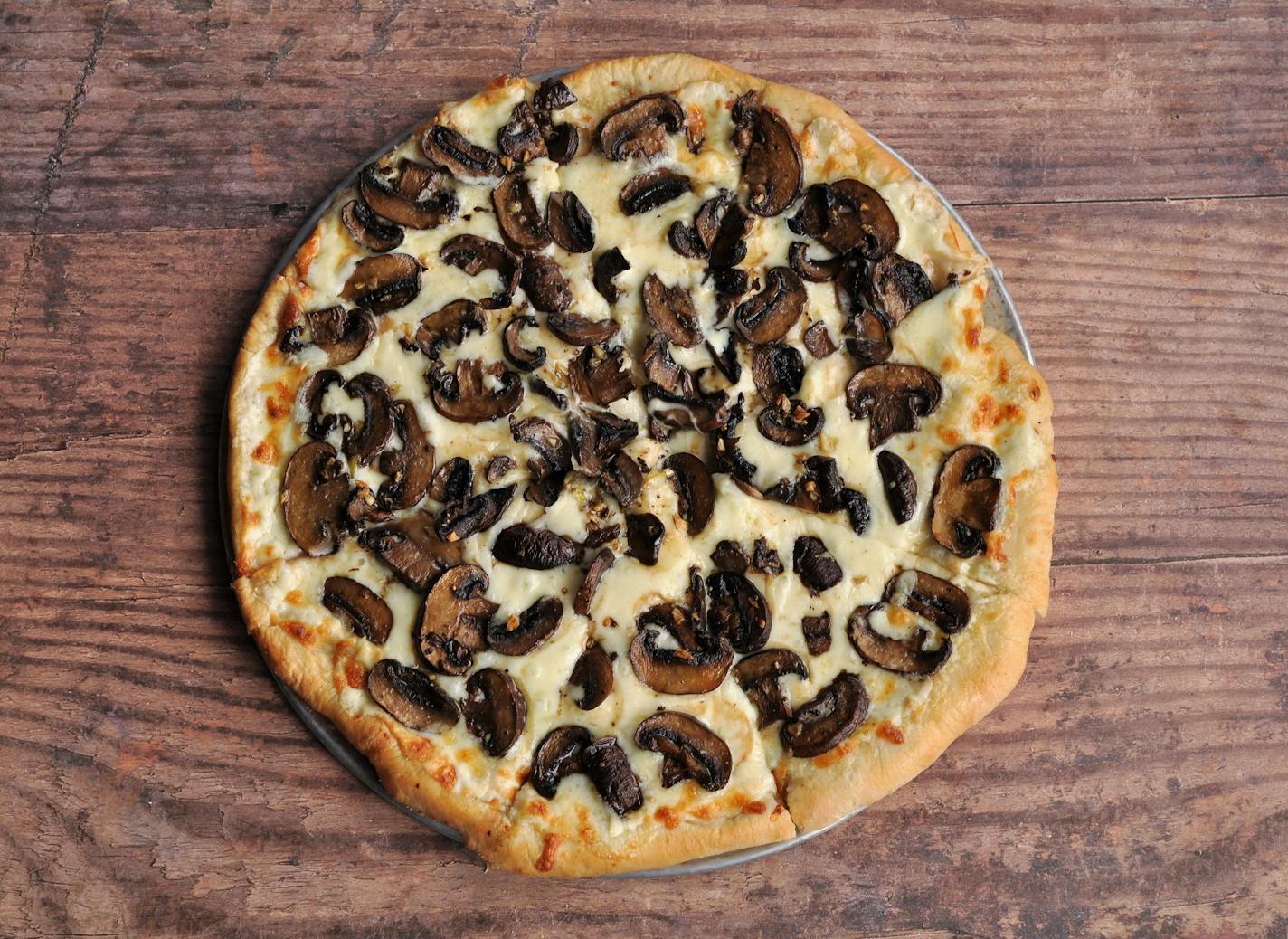 The crisp Roasted Mushroom Pizza is topped with mascarpone cheese. Meredith Deeds, Special to the Star Tribune