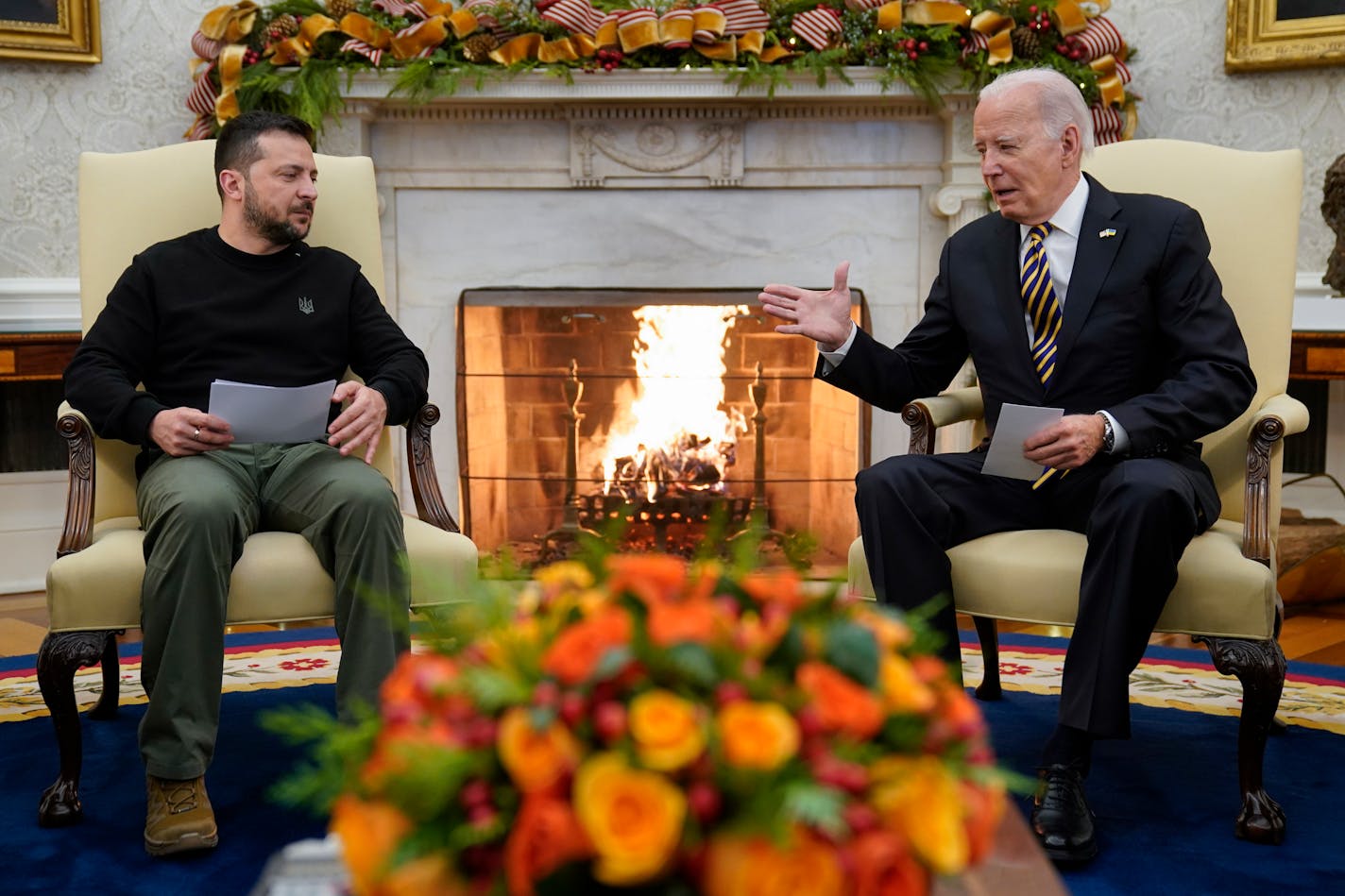 FILE - President Joe Biden reaches out to shake hands with Ukrainian President Volodymyr Zelenskyy as they meet in the Oval Office of the White House, Tuesday, Dec. 12, 2023, in Washington. The White House says funding for Ukraine has run out and it has been increasing pressure on Congress to pass stalled legislation to support the war against Russia. On Tuesday, however, Biden touted a new military aid package worth $200 million for Ukraine. That may seem contradictory, but it's due to the complex programs used to send aid to Ukraine. (AP Photo/Evan Vucci, File)