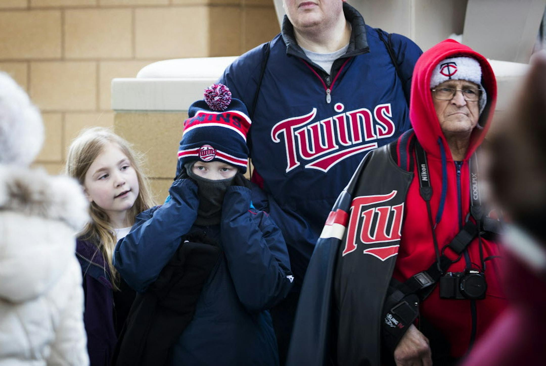 Owen Klaus, center, 9, and his sister McKinley, 6, wait in line before the game. ] LEILA NAVIDI ï leila.navidi@startribune.com BACKGROUND INFORMATION: The Minnesota Twins home opener against the Seattle Mariners at Target Field in Minneapolis on Thursday, April 5, 2018.