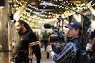 Camera operator Braden Dressel films a commercial for Explore Minnesota at The Market at Malcolm Yards in Minneapolis. The state is funneling more tha