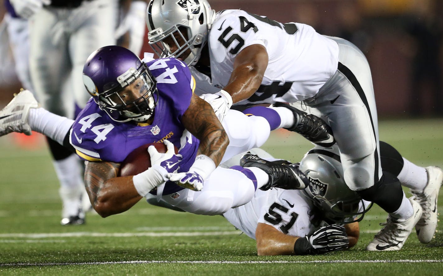 Vikings Matt Asiata picked up a first down in the second quarter after he was tackled by Raiders Ben Heeney . The Minnesota Vikings hosted the Oakland Raiders at TCF Bank Stadium Saturday August 22, 2015 in Minneapolis, MN. ] Jerry Holt/ Jerry.Holt@Startribune.com