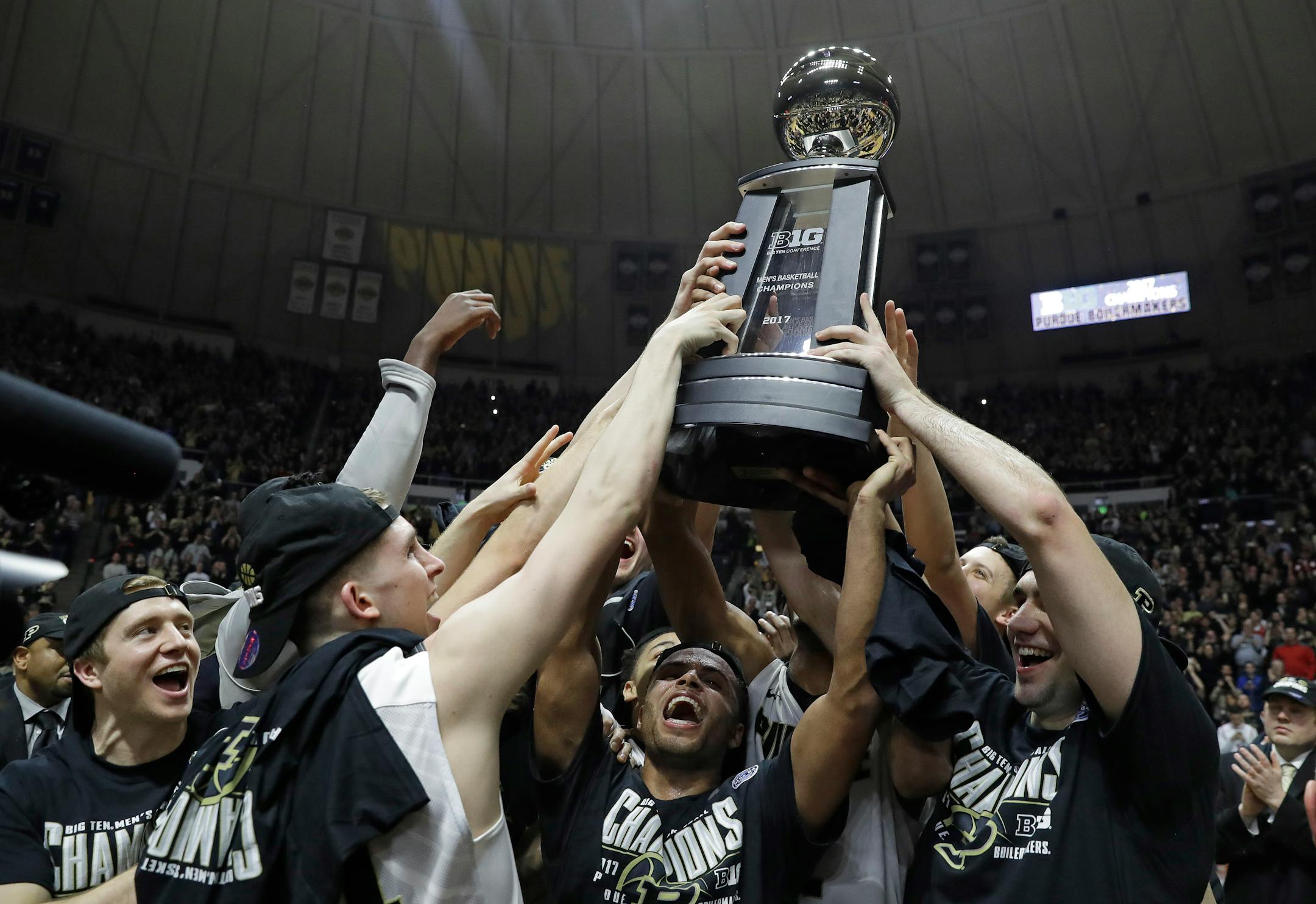 Members of the Purdue basketball team hold up the championship trophy after defeating Indiana 86-75 in an NCAA college basketball game Tuesday, Feb. 28, 2017, in West Lafayette, Ind. Purdue won a share of the Big Ten Conference regular season championship with the win. (AP Photo/Darron Cummings)