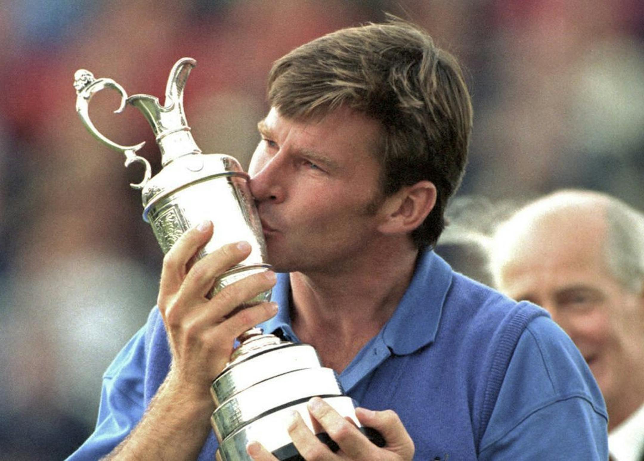 FILE - In this July 19, 1992, file photo, Britain's Nick Faldo kisses the trophy after he won the British Open golf tournament at Muirfield in Scotland. Faldo has won two British Opens at Muirfield. Faldo will play in the British Open next week for the 35th time; it is being held at Muirfield.