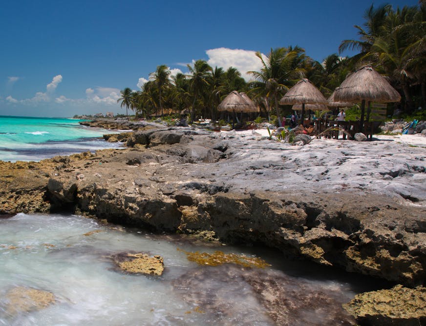 PHOTO MOVED IN ADVANCE AND NOT FOR USE - ONLINE OR IN PRINT - BEFORE DEC. 11, 2016. -- FILE -- Tourists at shaded tables along a rocky spot on the Yucatan coast in Tulum, Mexico, Aug. 2, 2014. By virtue of language, ease of transportation, expense or level of hospitality, some international travel destinations are especially well-suited to solo travelers. (David Freid/The New York Times)