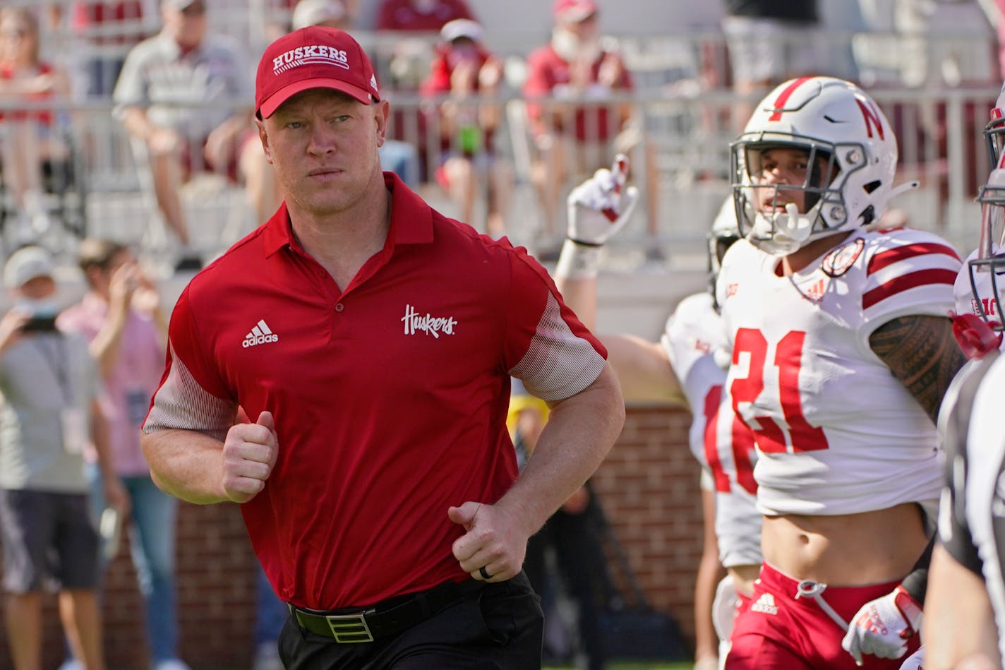 Nebraska head coach Scott Frost runs onto the field before an NCAA college football game against Oklahoma, Saturday, Sept. 18, 2021, in Norman, Okla. (AP Photo/Sue Ogrocki)