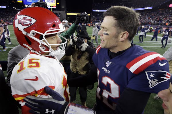 Kansas City Chiefs quarterback Patrick Mahomes, left, and New England Patriots quarterback Tom Brady speak at midfield after an NFL football game, Sun