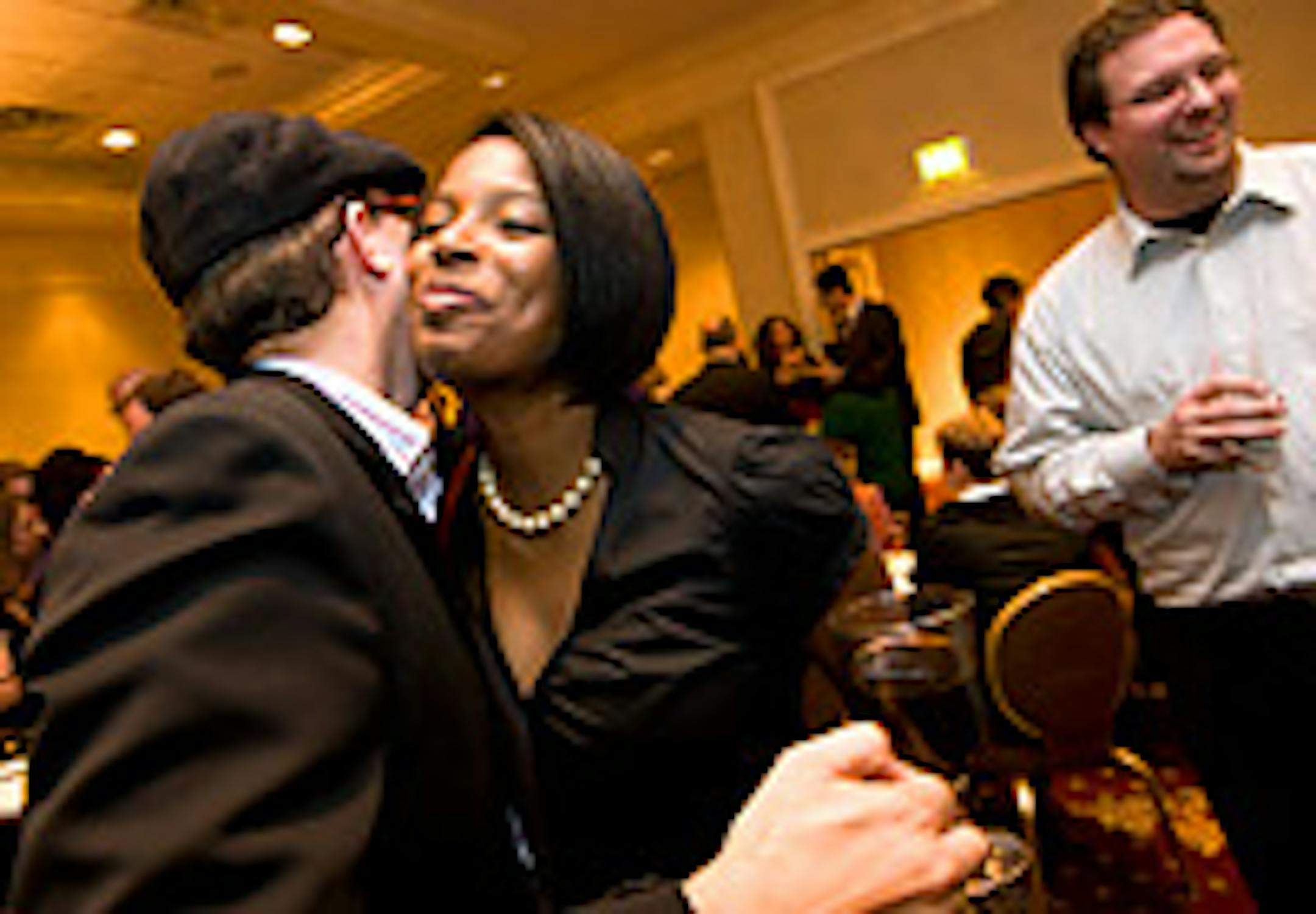 Nadege Souvenir greeted Daniel Zillmann as her husband, Jim Anderson, chatted with others at the Tempo gathering.