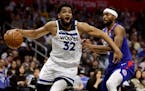 Minnesota Timberwolves center Karl-Anthony Towns, left, drives past Los Angeles Clippers forward Maurice Harkless during the first half of an NBA bask