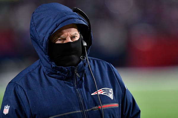 New England Patriots head coach Bill Belichick walks the sidelines during the second half of an NFL wild-card playoff football game against the Buffal