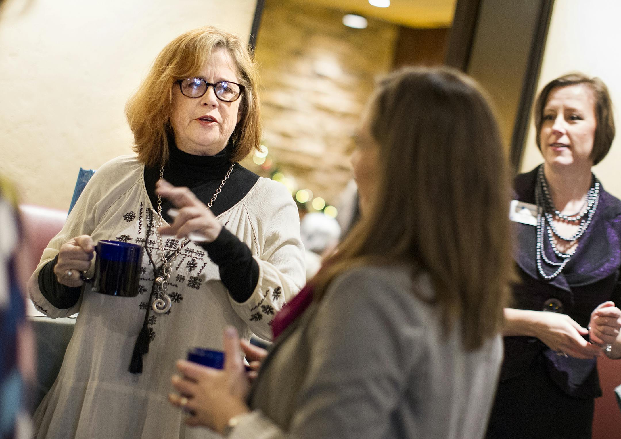 Kelly Pratt, left, of Creative Catalyst Studio, chats with fellow members of Women in Networking (WIN) during a monthly breakfast networking event at the Downtowner Woodfire Grill in St. Paul December 8, 2015. (Courtney Perry/Special to the Star Tribune)