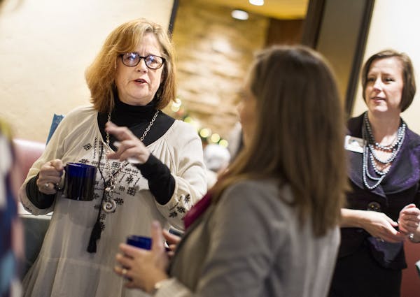 Kelly Pratt, left, of Creative Catalyst Studio, chats with fellow members of Women in Networking (WIN) during a monthly breakfast networking event at 