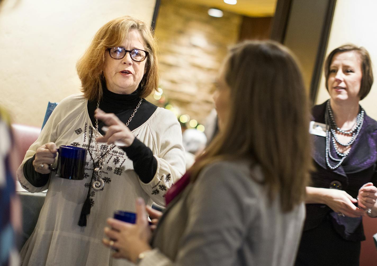 Kelly Pratt, left, of Creative Catalyst Studio, chats with fellow members of Women in Networking (WIN) during a monthly breakfast networking event at the Downtowner Woodfire Grill in St. Paul December 8, 2015. (Courtney Perry/Special to the Star Tribune)