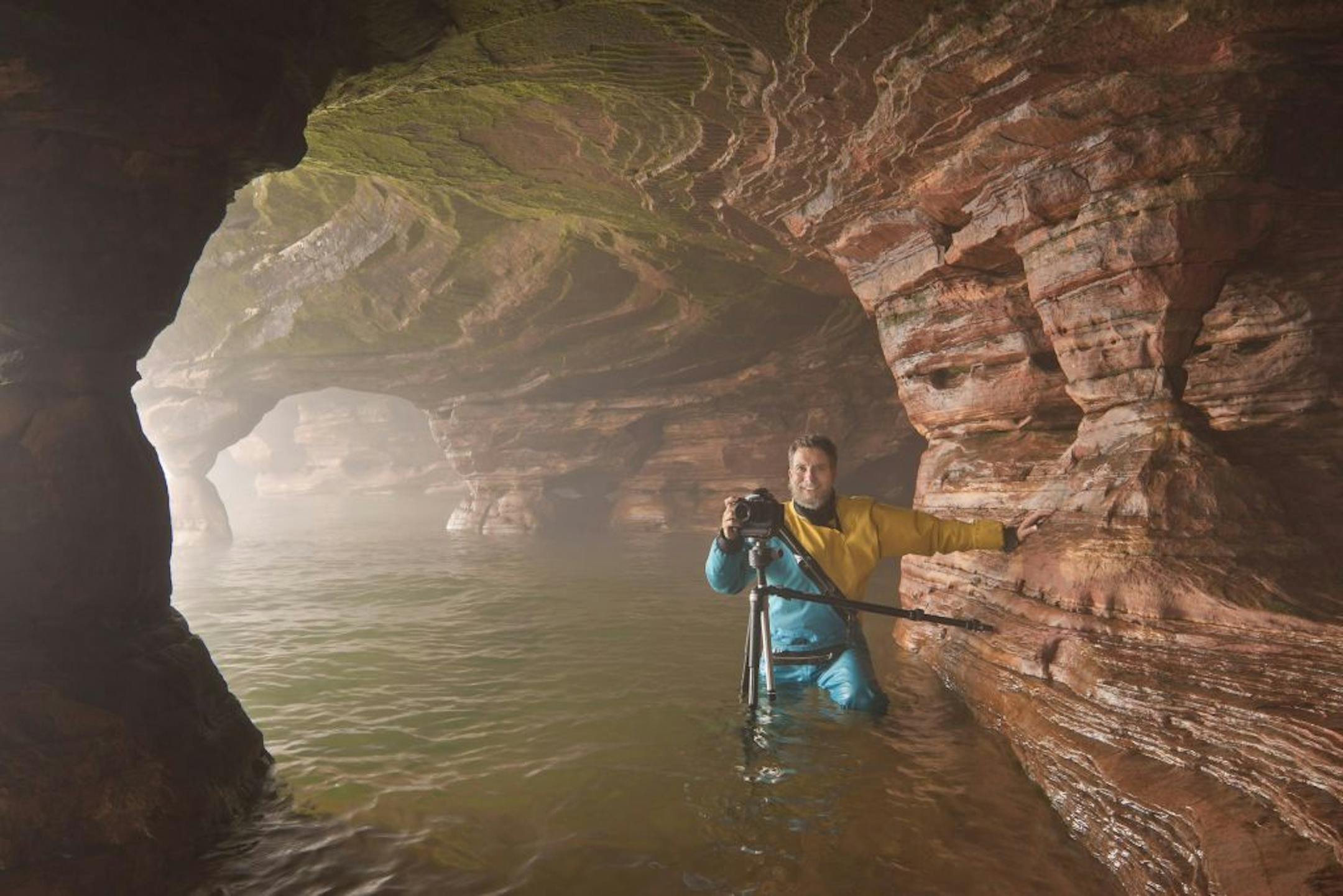 Craig Blacklock with camera inside sea cave at Swallow Point, Sand Island, Apostle Islands National Lakeshore.