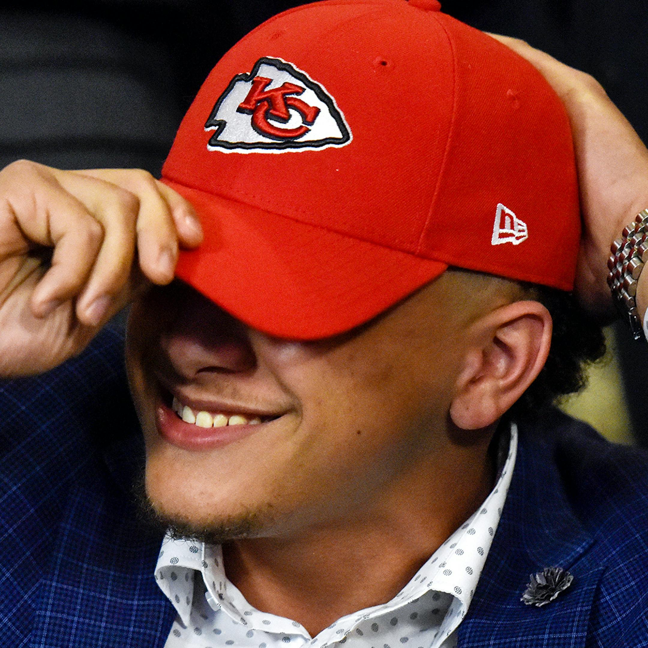 Patrick Mahomes II smiles as he puts on a Kansas City Chiefs hat during an NFL football draft watch party in Tyler, Texas, Thursday, April 27, 2017. Texas Tech quarterback Mahomes was the 10th overall pick by the Chiefs, after a trade with the Buffalo Bills. (Chelsea Purgahn/Tyler Morning Telegraph via AP) ORG XMIT: MIN2017042800540956