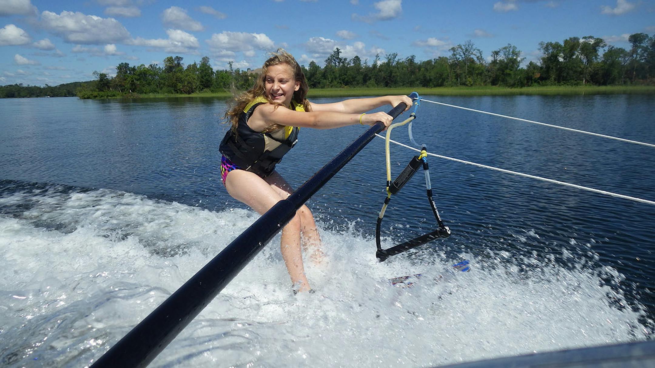 Kylie McClintick uses a boom for balance as she gets used to waterskis during a lesson at Madden's Resort on Gull Lake.