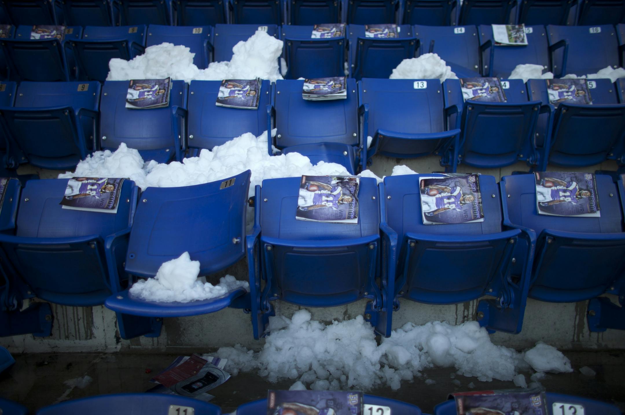 Programs were awaiting fans on the seats of the Metrodome Sunday morning. Snow fell through the gaping hole in the roof and landed on seats in the upper deck.