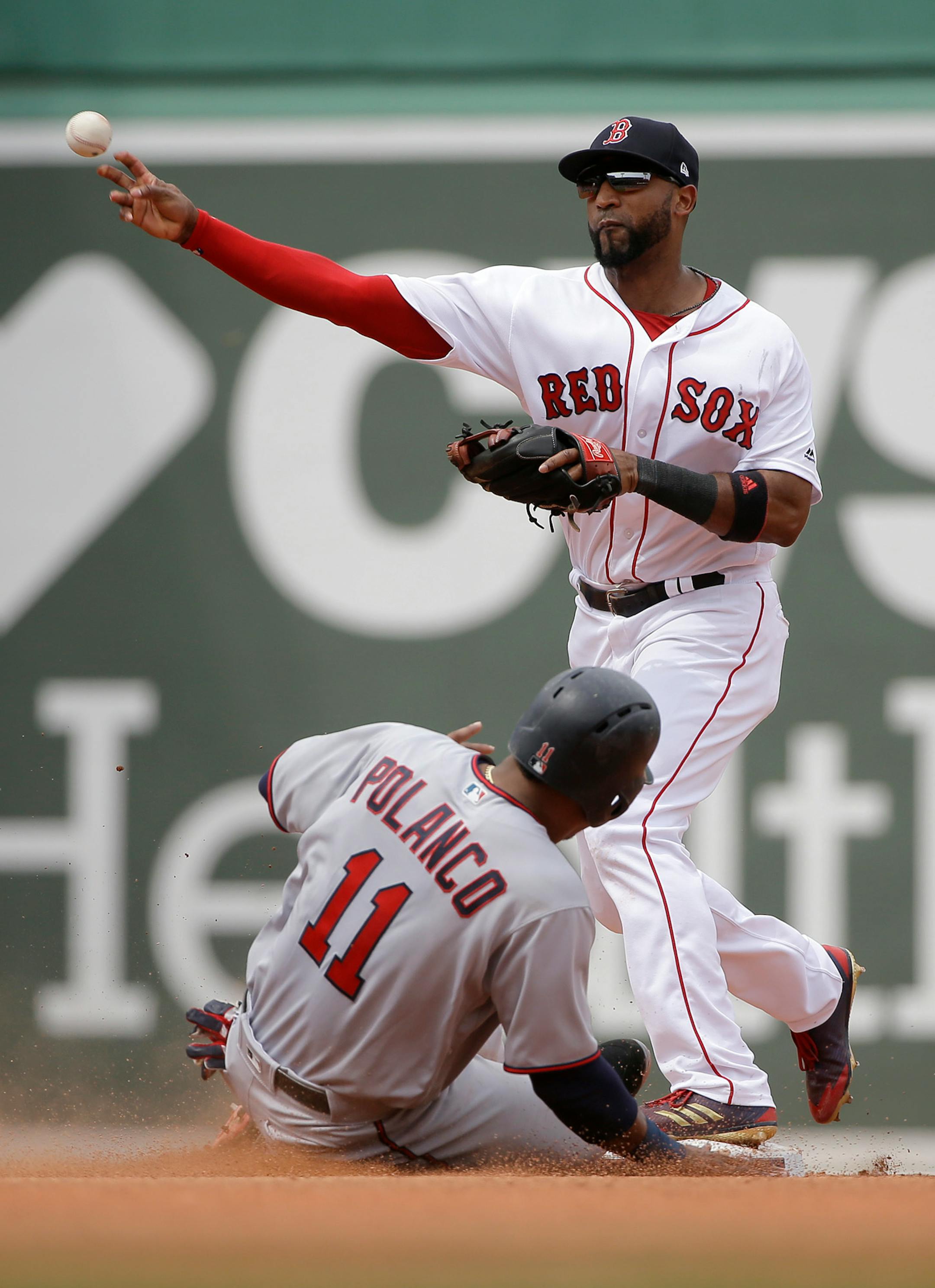 Minnesota Twins' Jorge Polanco, below, slides out at second base as Boston Red Sox's Eduardo Nunez, top, throws to first base to complete a double play in the fourth inning of a baseball game, Sunday, July 29, 2018, in Boston. (AP Photo/Steven Senne)