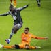 Minnesota United forward Kei Kamara (16) jumped over Houston Dynamo defender Victor Cabrera (36) during the second half of an MLS match in St. Paul, M