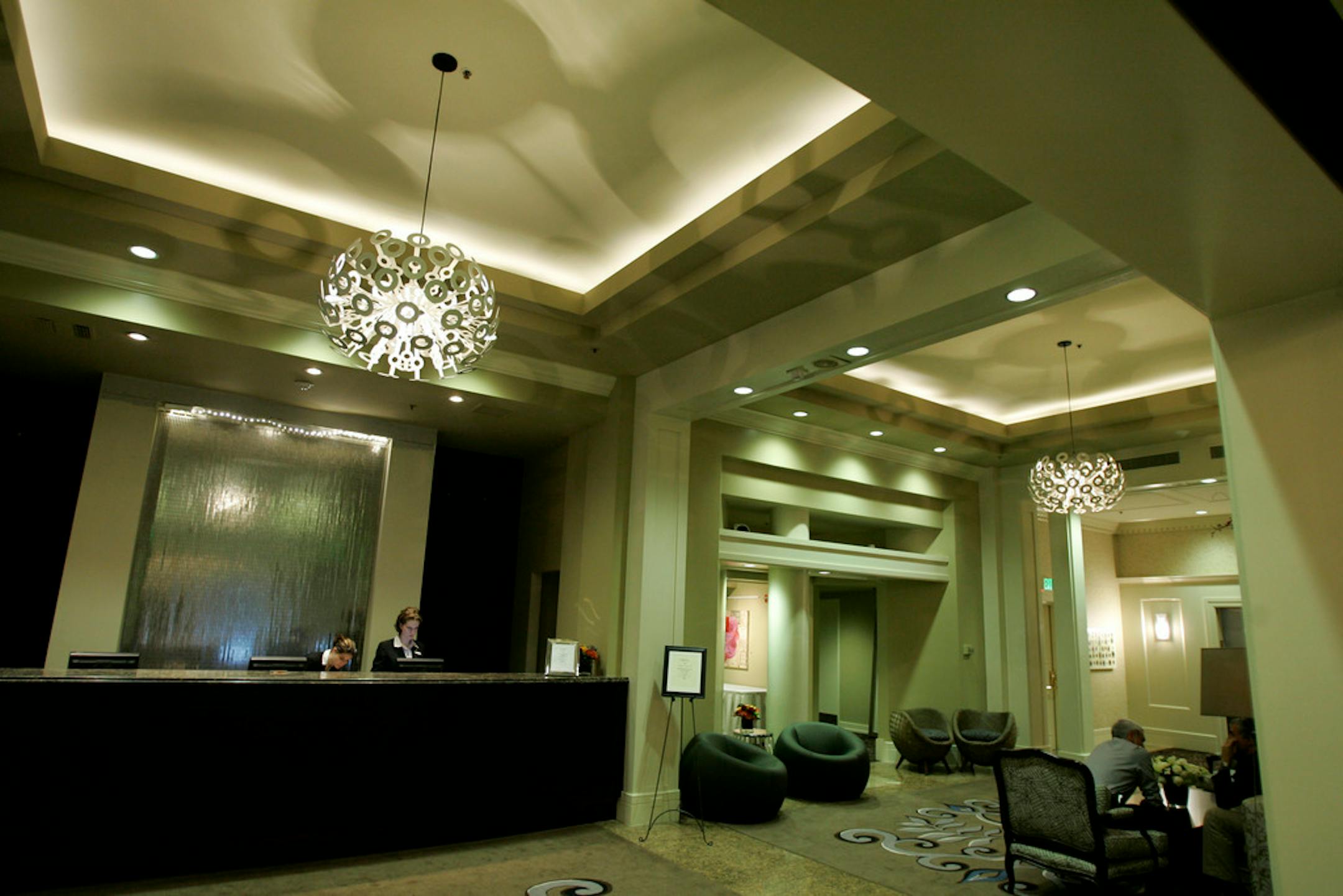 The front desk and lobby of the Alexis hotel is shown in downtown Seattle Wednesday, Oct. 24, 2007. The hotel is in the historic Globe Building, which was built in 1901. It recently underwent a $10 million renovation, and guest rooms feature stainless steel four-poster beds, rococo mirrors, 300-thread-count sheets and high-definition televisions. The exposed beam features of the ceiling were retained from the historic past of the building.