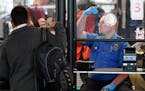 A TSA agent signals for the next airline passenger in line at a security checkpoint in Chicago's O'Hare International Airport Friday, May 26, 2023. (A