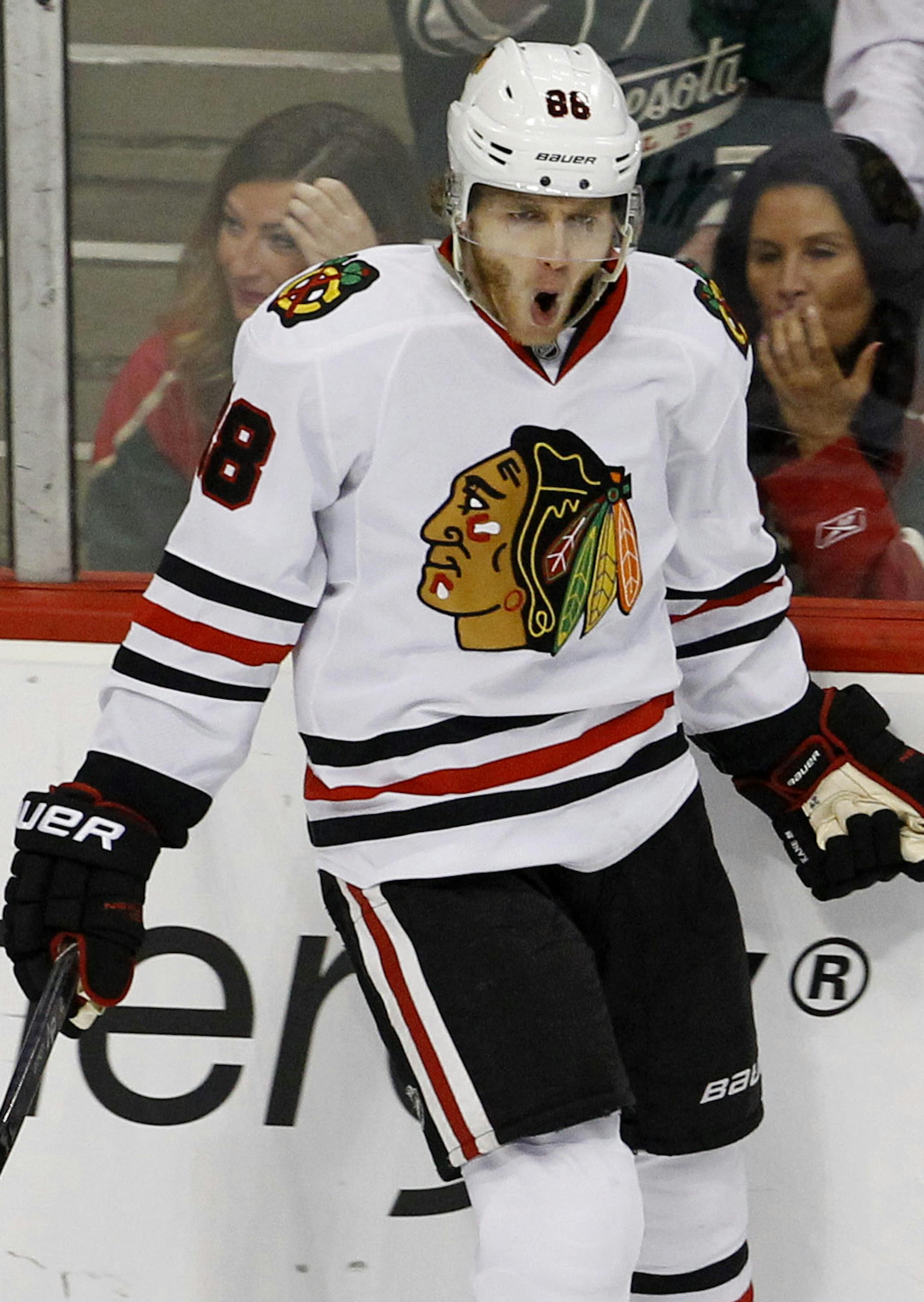 Chicago Blackhawks right wing Patrick Kane celebrates after scoring on Minnesota Wild goalie Devan Dubnyk during the first period of Game 3 in the second round of the NHL Stanley Cup hockey playoffs in St. Paul, Minn., Tuesday, May 5, 2015. The Blackhawks won 1-0. (AP Photo/Ann Heisenfelt)