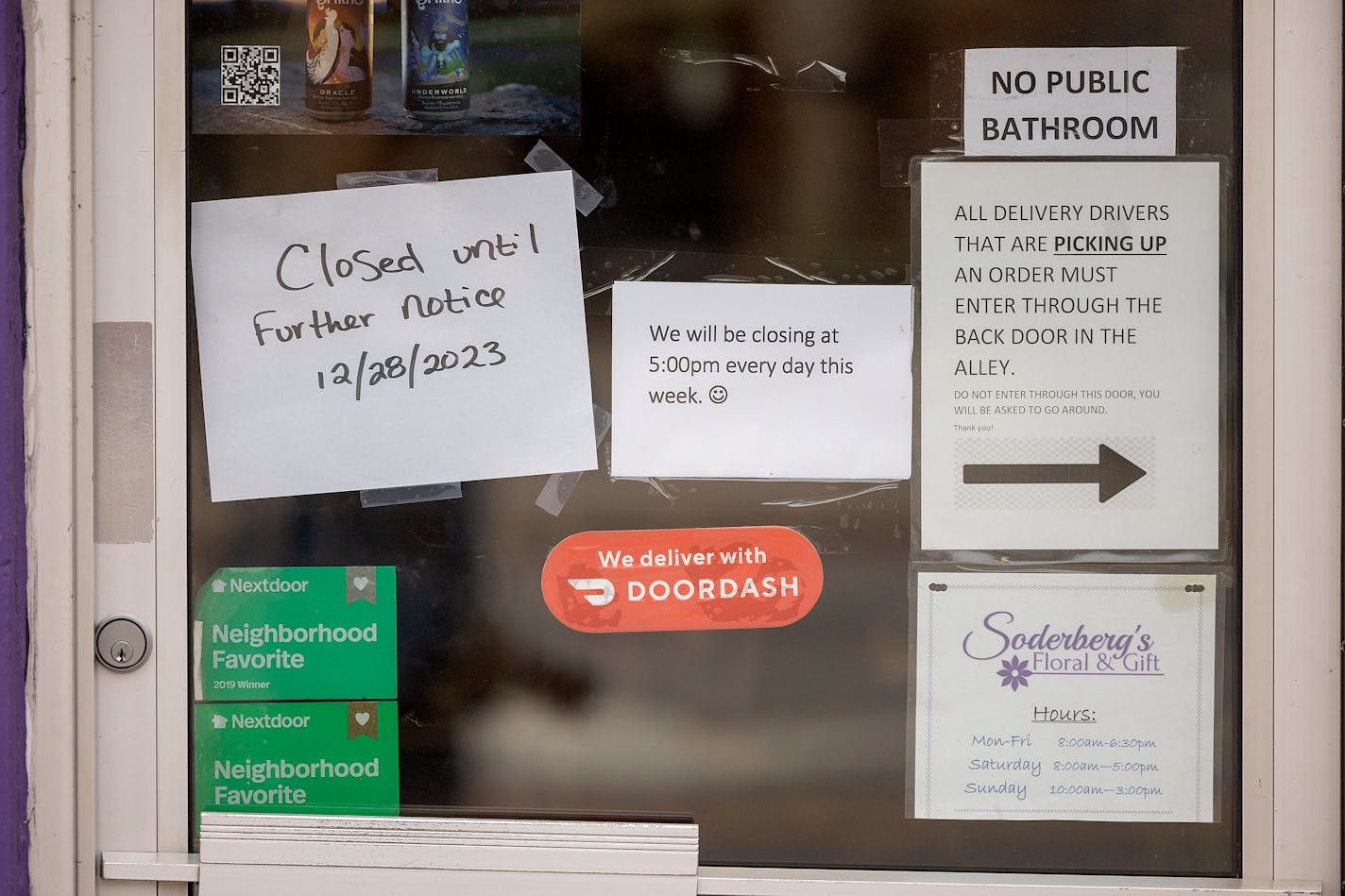 A written closed sign is one of many signs on the door at Soderberg Floral and Gifts in Minneapolis, Minn., on Friday, Jan. 5, 2024. After 99 and a half years on Lake Street, Soderberg Floral and Gifts abruptly shut this week, ending a lynchpin for the Long Fellow neighborhood. ] Elizabeth Flores • liz.flores@startribune.com